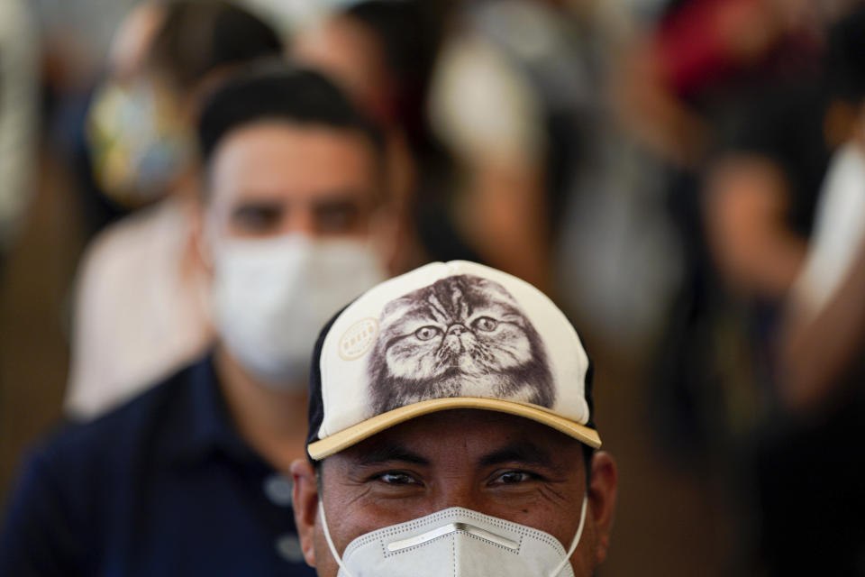 A man smiles after getting his shot of Russia's Sputnik V coronavirus vaccine during a vaccination drive at University Stadium in Mexico City, Friday, July 23, 2021. So far, about 42.4 million people have been vaccinated, according to the health ministry. That is about 47% of the adult population, and about 30% of the total population. (AP Photo/Fernando Llano)