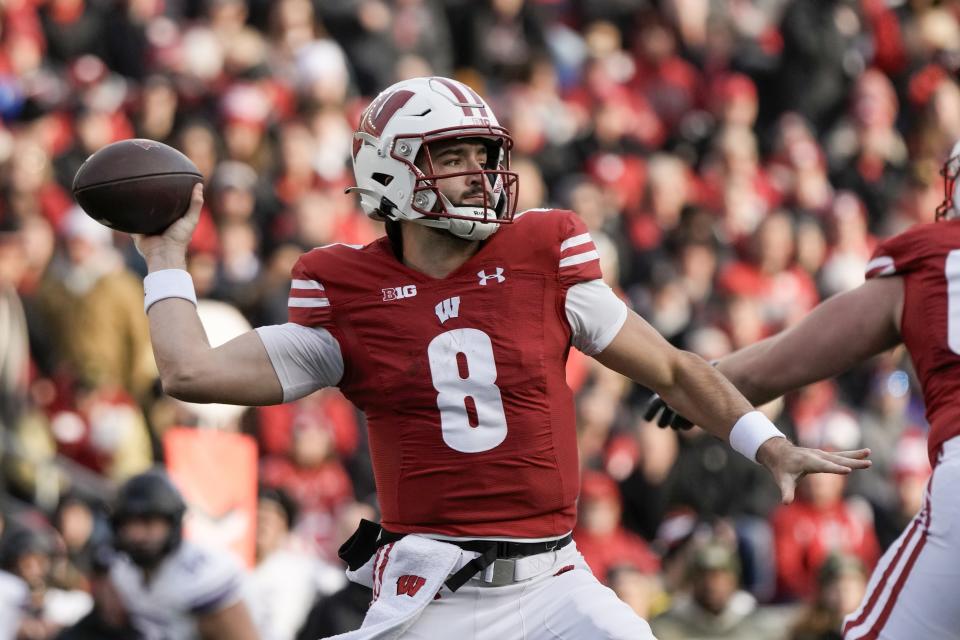 Wisconsin's Tanner Mordecai (8) throws during the first half of an NCAA college football game against Northwestern Saturday, Nov. 11, 2023, in Madison, Wis. (AP Photo/Morry Gash)