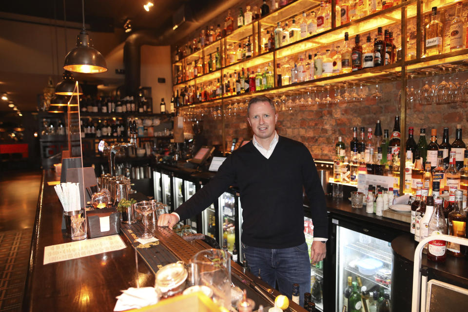 Paul Cadden, owner of the Saba restaurant group poses for a photograph in his restaurant in Dublin, Ireland, Wednesday, Oct. 21, 2020. Paul Cadden will have to lay off 20 people, but will do whatever is necessary to get through lockdown. With COVID-19 cases on the rise, the government has imposed a tough new lockdown, shutting down non-essential shops, limiting restaurants to takeout service and ordering people to stay within five kilometers (three miles) of their homes for the next six weeks. (AP Photo/Peter Morrison)