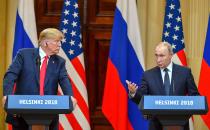 <p>US President Donald Trump (L) listens as Russia’s President Vladimir Putin speaks during a joint press conference after a meeting at the Presidential Palace in Helsinki, on July 16, 2018. (Photo: Yuri Kadobnov/AFP/Getty Images) </p>