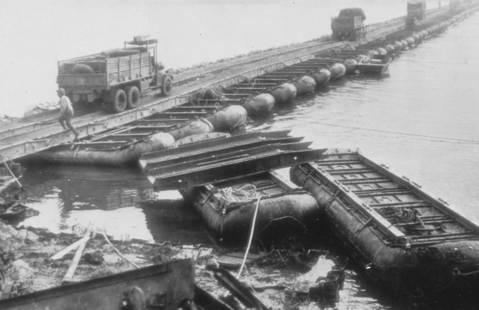 U.S. trucks cross the Rhine River into Germany in 1945 on a pontoon bridge constructed by Army engineers.