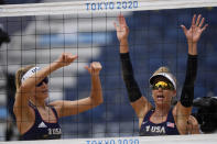 April Ross, right of the United States, and teammate Alix Klineman, left, wave to the stands after they won a women's beach volleyball match against Cuba at the 2020 Summer Olympics, Monday, Aug. 2, 2021, in Tokyo, Japan. (AP Photo/Petros Giannakouris)