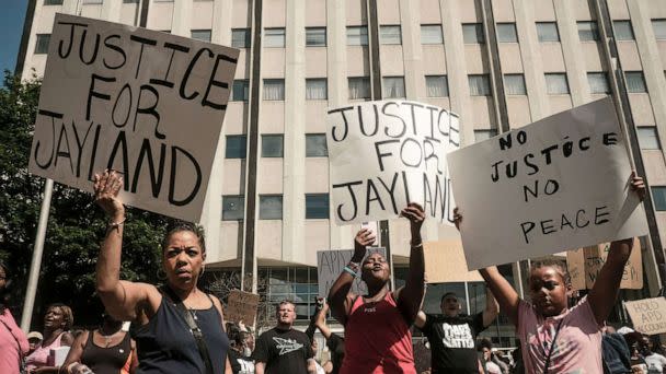 PHOTO: Demonstrators hold 'Justice for Jayland' signs as they gather outside Akron City Hall to protest the killing of Jayland Walker, shot by police, in Akron, Ohio, July 3, 2022. (Matthew Hatcher/AFP via Getty Images)