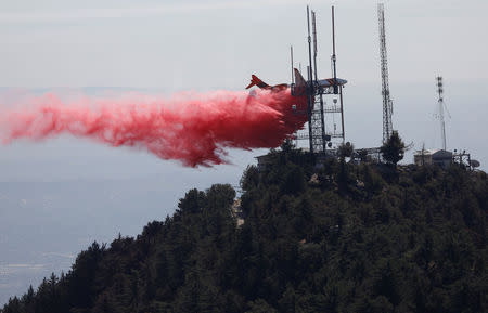 An air tanker drops fire retardant while battling the Wilson Fire near Mount Wilson in the Angeles National Forest in Los Angeles, California, U.S. October 17, 2017. REUTERS/Mario Anzuoni