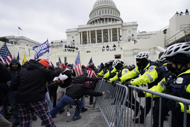 FILE - In this Wednesday, Jan. 6, 2021 file photo, Trump supporters try to break through a police barrier at the Capitol in Washington. The House committee investigating the violent Jan. 6 Capitol insurrection, with its latest round of subpoenas in September 2021, may uncover the degree to which former President Donald Trump, his campaign and White House were involved in planning the rally that preceded the riot, which had been billed as a grassroots demonstration. (AP Photo/Julio Cortez, File)