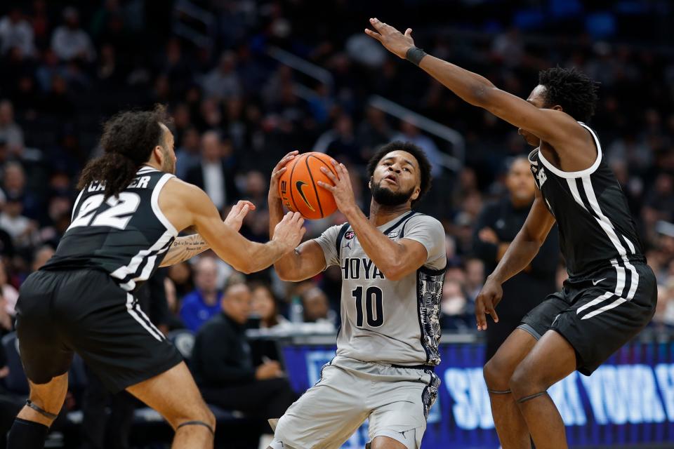 Georgetown guard Jayden Epps (10) drives to the basket as Providence guards Devin Carter (22) and Jayden Pierre (1) defend in the second half of Tuesday's game at Capital One Arena.