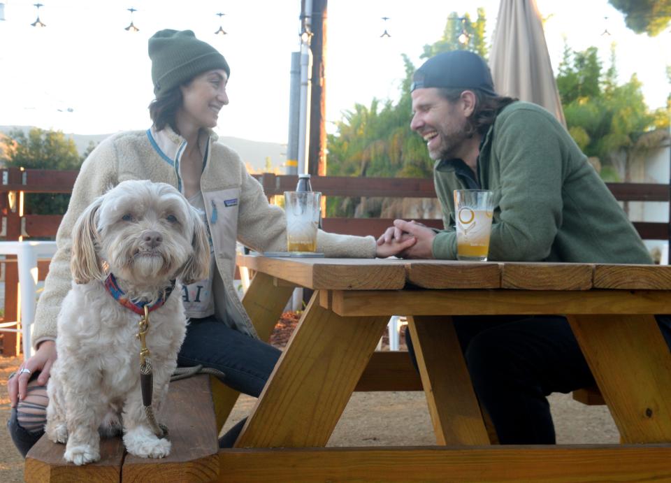 Alicia Strait enjoys the outside patio with her husband Ryan Anthony and their dog Burt at the Ojai Valley Brewery on Wednesday, Nov. 10, 2021.