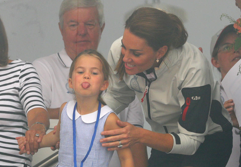 The Duchess of Cambridge with Princess Charlotte look through a window at the prize giving after the King's Cup regatta at Cowes on the Isle of Wight.