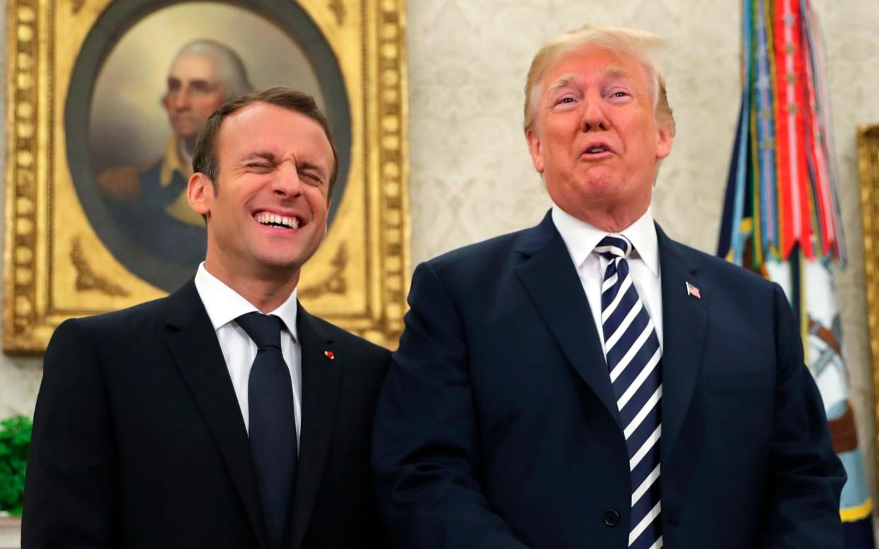 Emmanuel Macron and Donald Trump laugh together in the White House during a three-day state visit by the French president  - AP