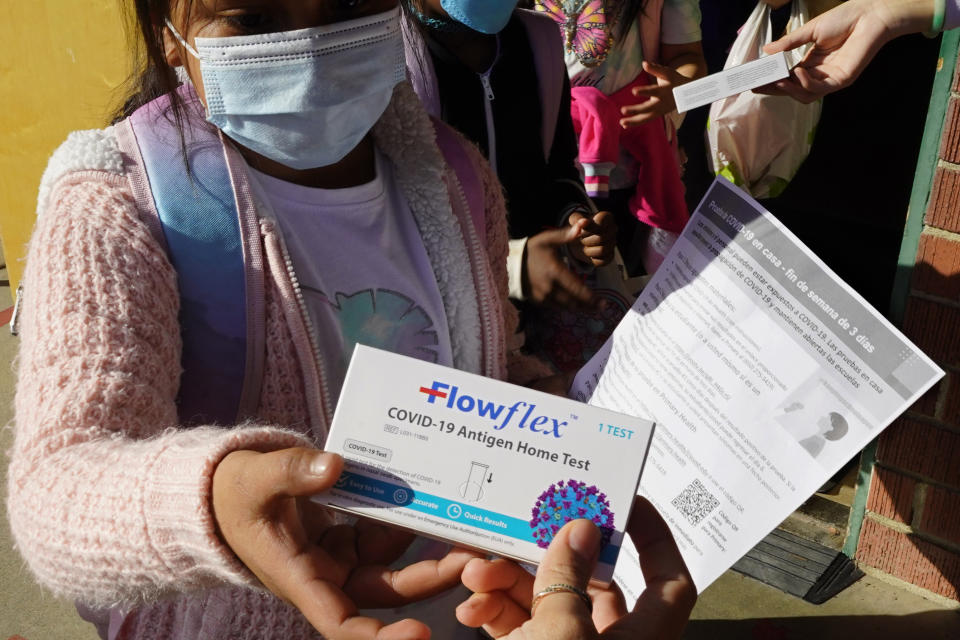 FILE - A second grade student is given a at-home COVID-19 test at H.W. Harkness Elementary School in Sacramento, Calif., on Feb. 11, 2022. As a new school year approaches, COVID-19 infections are again on the rise, fueled by highly transmissible variants, filling families with dread. They fear the return of a pandemic scourge: outbreaks that sideline large numbers of teachers, close school buildings and force students back into remote learning.(AP Photo/Rich Pedroncelli, File)