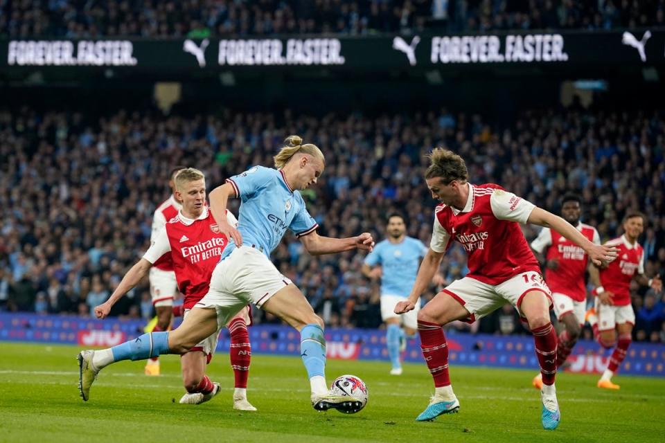 Erling Haaland takes on Rob Holding in the box (AP)