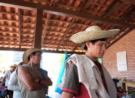 Men attend a meeting during the 10th Indigenous March to defend Mother Earth, near San Jose