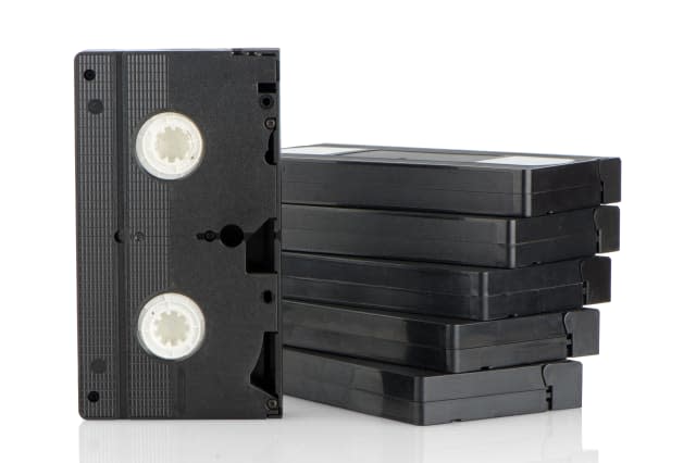 Pile of videotapes on  white reflective background.