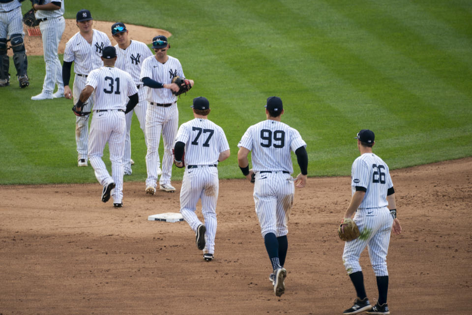 The New York Yankees celebrate their 11-4 win after a baseball game against the Miami Marlins at Yankee Stadium, Saturday, Sept. 26, 2020, in New York. (AP Photo/Corey Sipkin)