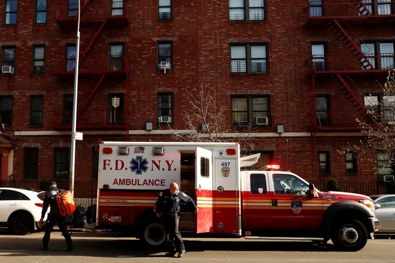 New York City Fire Department (FDNY) Emergency Medical Technicians (EMT) wearing personal protective equipment arrive to assist a woman who was having difficulty breathing during ongoing outbreak of the coronavirus disease (COVID19) in New York