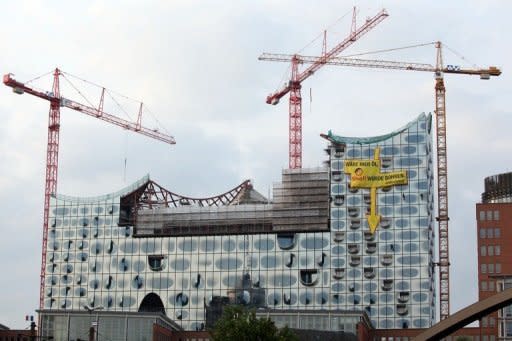 Greenpeace activists climb the Elbe Philharmonic Hall in Hamburg, northern Germany, on August 23, 2013 to protest plans for drilling in the Arctic. The group says it has deployed its icebreaker through an Arctic shipping route to protest against oil drilling in the fragile ecosystem, defying Russian authorities