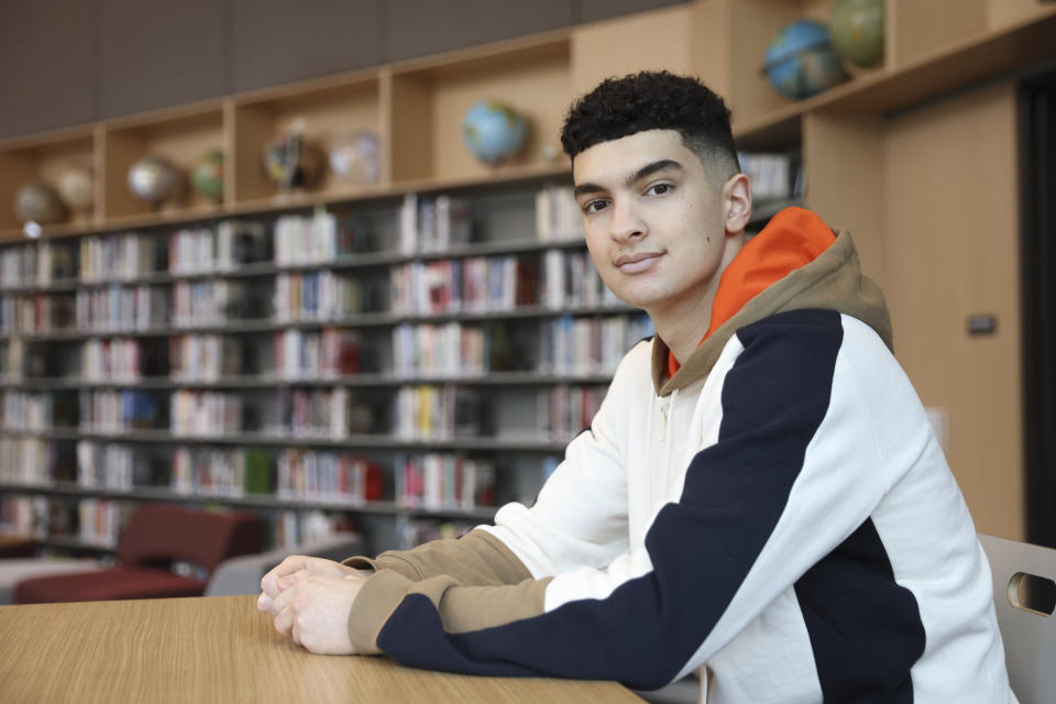 Max Decker, a senior at Lincoln High School, sits for a portrait in the school library where he often worked on writing his college essays, in Portland, Ore., Wednesday, March 20, 2024. (AP Photo/Amanda Loman)