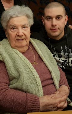 A young man and an elderly lady.