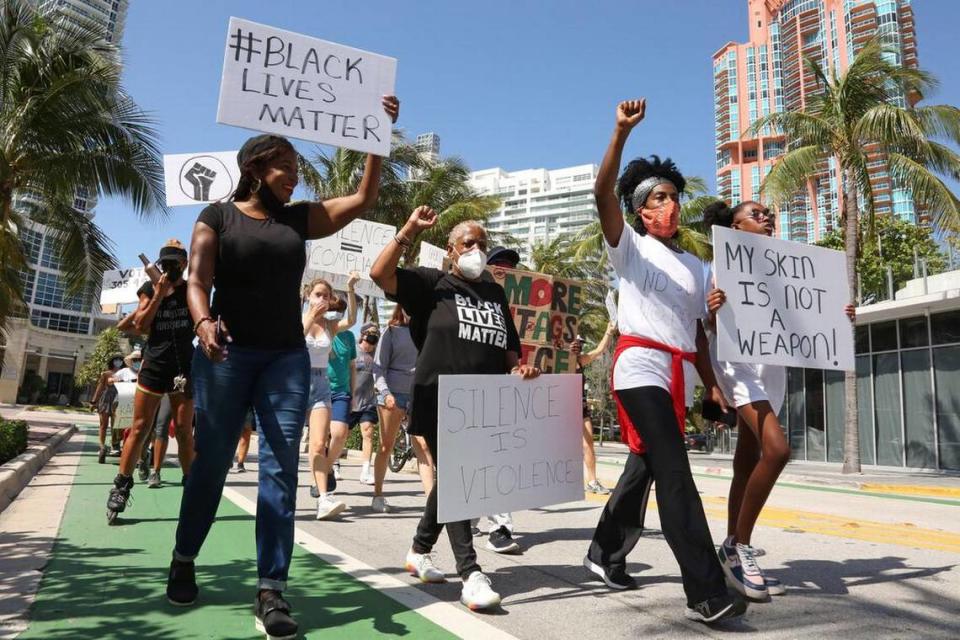 from right: Egyptia Green, 13, and her mother Bridjette Hoilett-Green, lead a group of demonstrators as they march toward Ocean Drive during a protest demanding justice for Black lives in Miami Beach, Florida, Saturday, June 20, 2020.