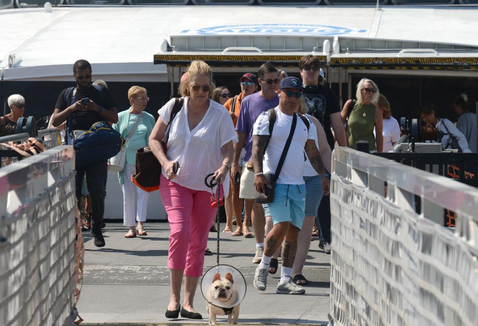 Arriving passengers walk off the ferry Iyanough on Wednesday at the Woods Hole, Martha's Vineyard and Nantucket Steamship Authority fast ferry terminal in Hyannis. "We are back to business as usual,” Peter Jeffrey, Steamship Authority board member from Falmouth, said Tuesday of post-COVID ridership.