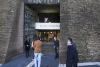 The first visitors of the day enter the Vatican Museums, at the Vatican, Monday, Feb. 1, 2021. The Vatican Museums reopened Monday to visitors after 88 days of shutdown following COVID-19 containment measures. (AP Photo/Andrew Medichini)