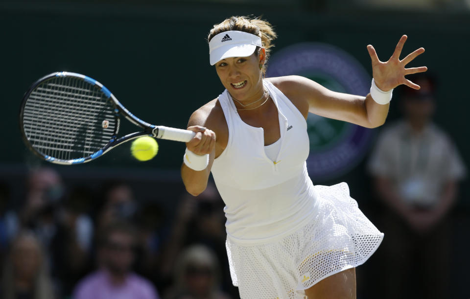 Garbine Muguruza of Spain returns a shot to Serena Williams of the United States during the women's singles final at the All England Lawn Tennis Championships in Wimbledon, London, Saturday July 11, 2015. (AP Photo/Kirsty Wigglesworth)