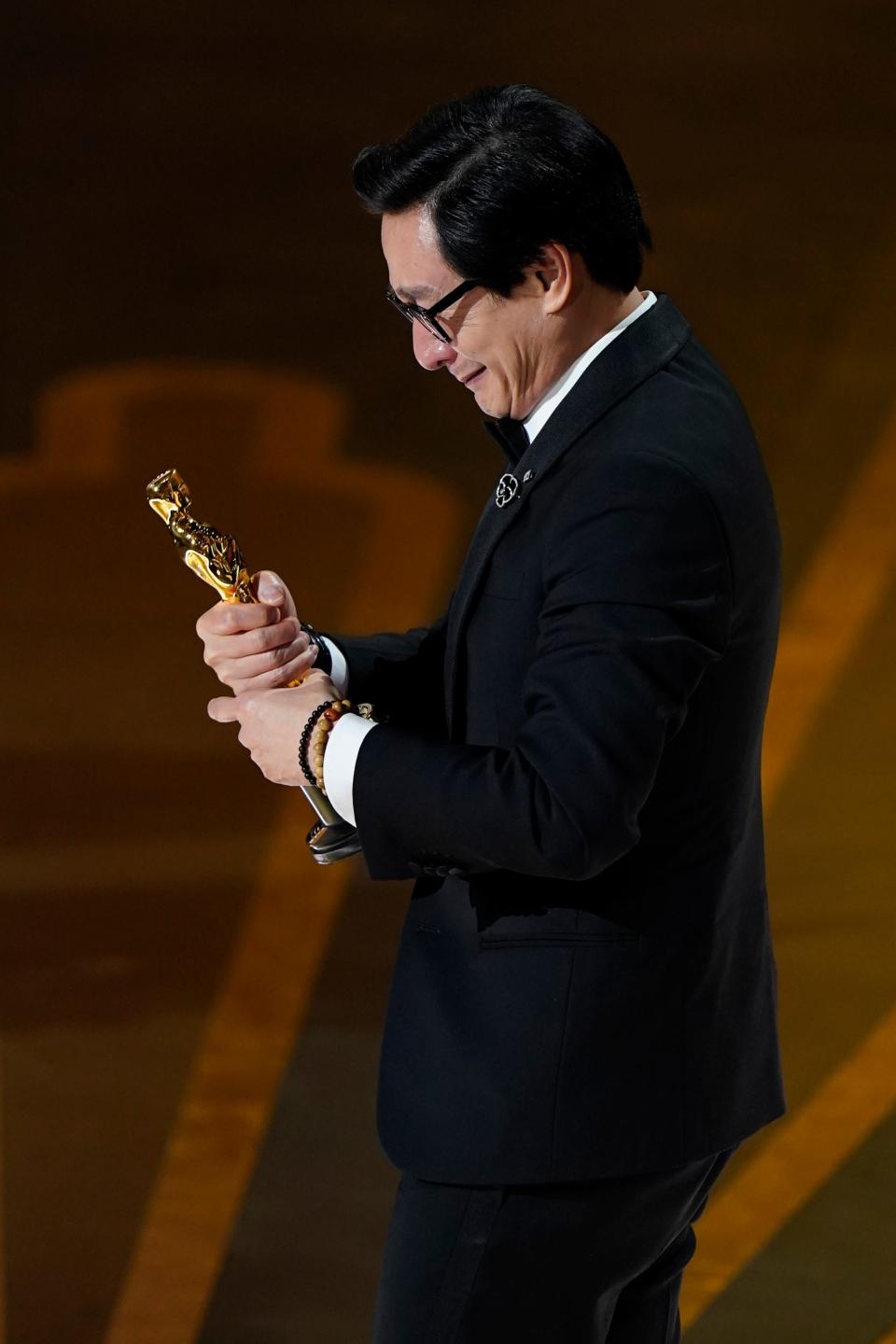 Ke Huy Quan looks at his Oscar for best supporting actor for "Everything Everywhere All at Once."