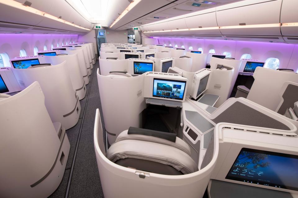 Purple mood lighting aligns this first-class cabin on Fiji Airways.