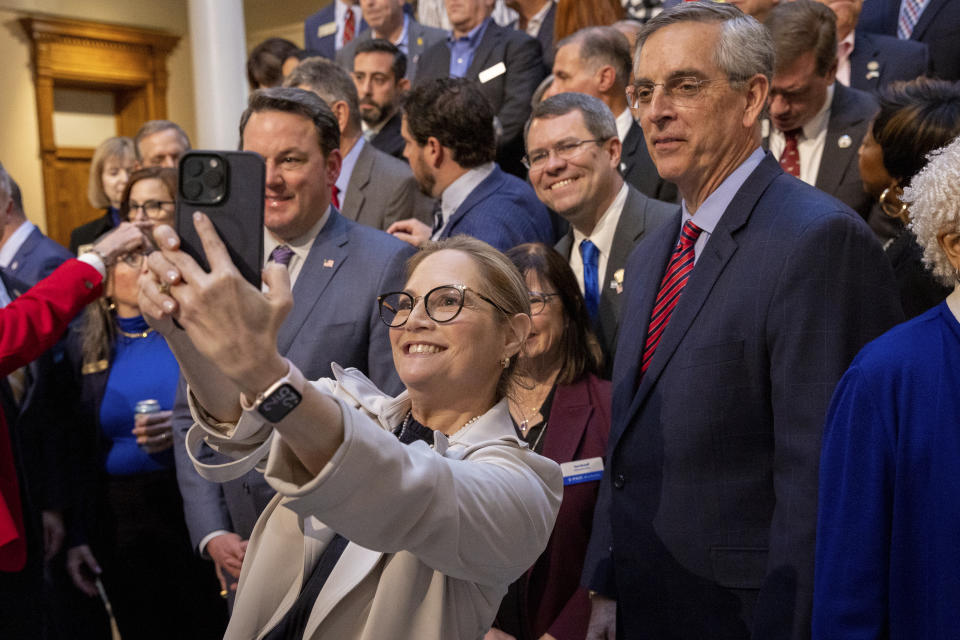 Rep. Esther Panitch, D-Sandy Springs, takes a selfie before Gov. Brian Kemp signs an antisemitism bill HB 30 at the Capitol in Atlanta, on Wednesday, Jan. 31, 2024. Patnitch is the only Jewish member of the Georgia General Assembly. (Arvin Temkar/Atlanta Journal-Constitution via AP)