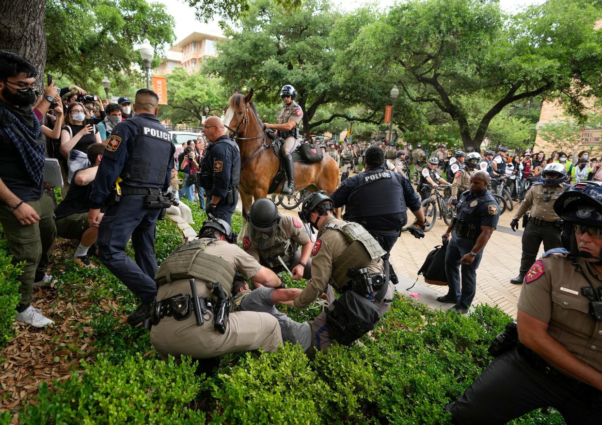 DPS troopers arrest a man at Wednesday's protest.