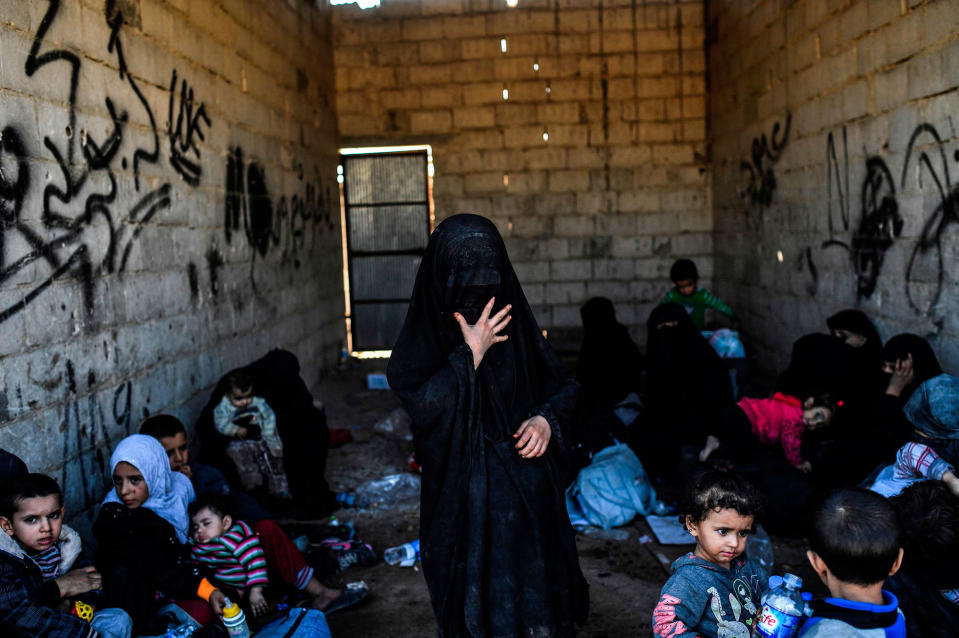 <p>Syrian women and children gather on the western front after fleeing the center of Raqqa on Oct. 12, 2017. (Photo: Bulent Kilic/AFP/Getty Images) </p>