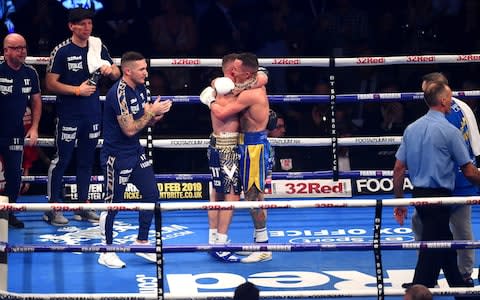 Josh Warrington and Carl Frampton embrace after the IBF World Featherweight Championship title  - Credit: Getty Images