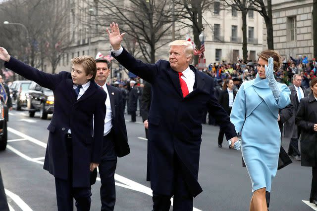 <p>Evan Vucci - Pool/Getty</p> Barron, Donald and Melania Trump walk in an Inauguration Day parade on Jan. 20, 2017