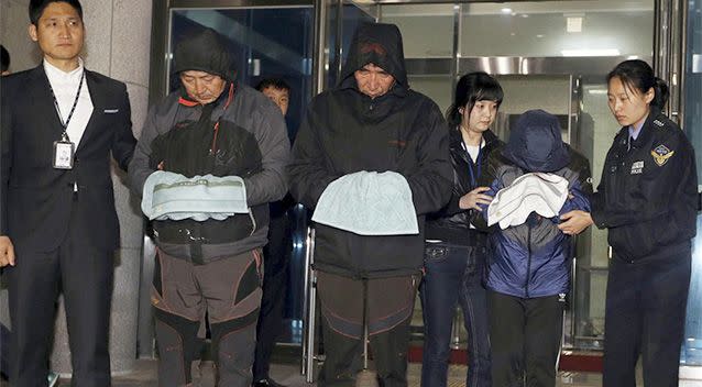 Lee Joon-seok, third from left, the captain of the ferry Sewol that sank off South Korea, and two crew members prepare to leave a court which issued their arrest warrant in Mokpo, south of Seoul, South Korea. Photo: AP.