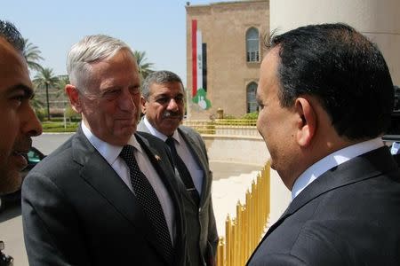 Iraq's Defence Minister Erfan al-Hiyali (R), welcomes U.S. Defense Secretary Jim Mattis, in Baghdad, Iraq August 22, 2017. REUTERS/Stringer