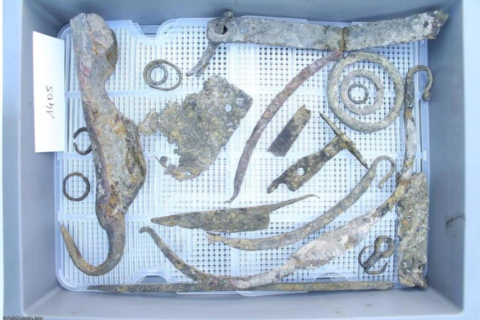 Metal artifacts, including a knife and bucket handles, found in the canal.