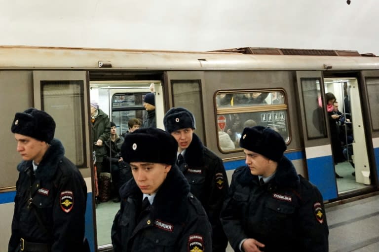 Russian police officers patrol at Prospekt Mira metro station on April 4, 2017 in Moscow, as security measures are tightened following the blast in the Saint Petersburg metro