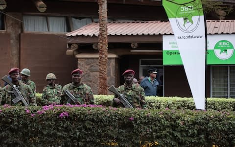 Kenya police officers stand guard ahead of Friday's announcement - Credit: EPA