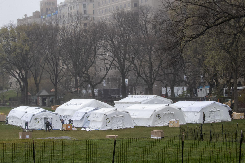 A Samaritan's Purse crew works on building an emergency field hospital specially equipped with a respiratory unit in New York's Central Park across from The Mount Sinai Hospital, Sunday, March 29, 2020. (AP Photo/Mary Altaffer, File)