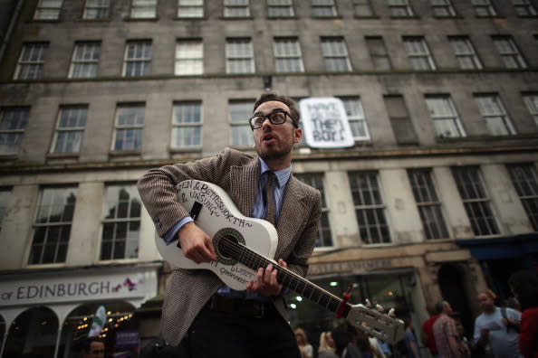 Street entertainers perform on the Royal Mile to promote their shows during in the Edinburgh Fringe Festival on August 6, 2012 in Edinburgh, Scotland. The Edinburgh Festival Fringe is the largest arts festivals in the world, it was established as an alternative to the International Festival also held in August, and celebrates it's 66th anniversary this year. (Photo by Dan Kitwood/Getty Images)