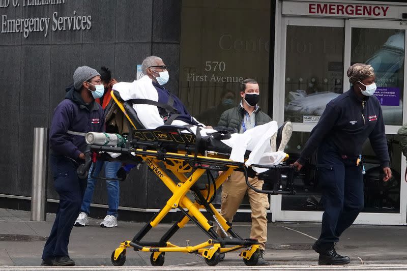 A man is wheeled out of a hospital on a stretcher in New York