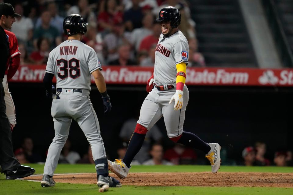 Cleveland Guardians' Gabriel Arias, right, celebrates with Steven Kwan (38) after scoring on a single by Bo Naylor on Sept. 8 against the Los Angeles Angels in Anaheim, Calif.