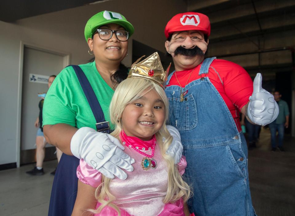 Kelly Keo, left, Sophal Lek of Stockton and their 6-year-old daughter Sophia Keo dressed as Nintendo's Luigi, Mario and Princess Peach at the annual StocktonCon at the Stockton Arena in downtown Stockton on Saturday, August, 13, 2022.  