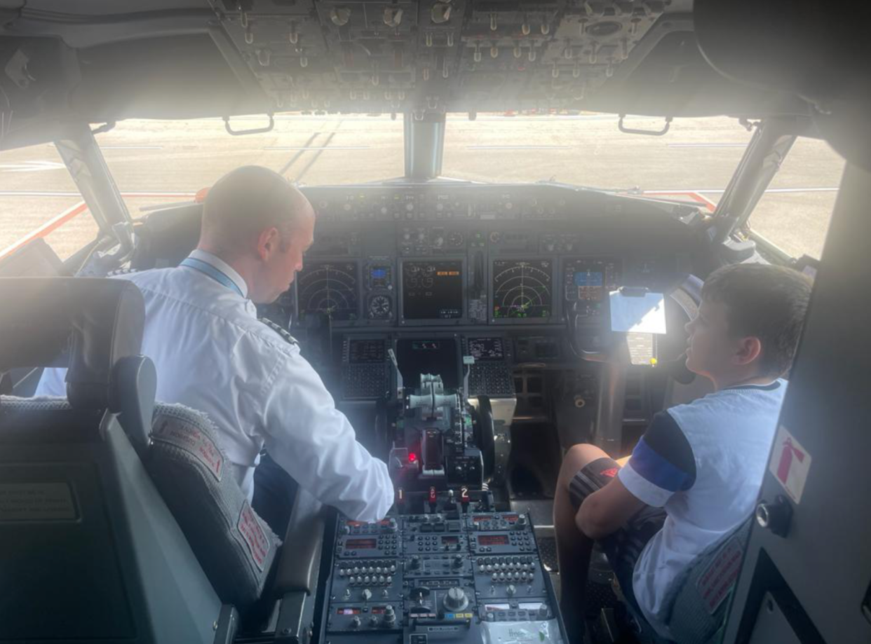 11-year-old Danny was ‘over the moon’ to be shown round the cockpit as the Magarottos’ flight was held on the tarmac (Spencer Magarotto)