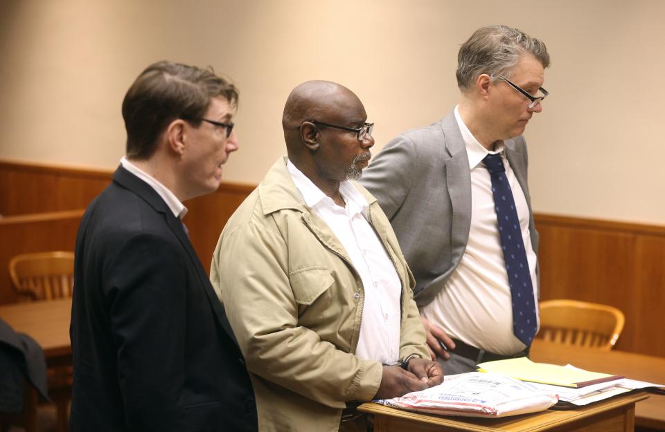 Michael Rhynes listens as he hears that his double murder conviction vacated celebrates after leaving the courtroom. He is with his attorneys Robert Grossman (L) and Pierre Sussman.
