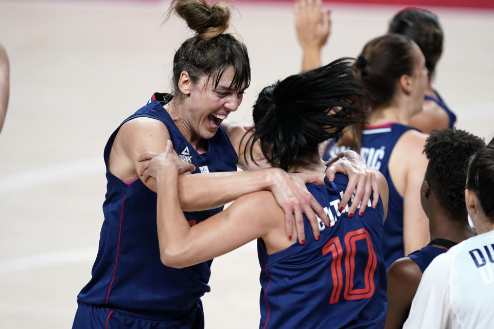 Serbia's Tina Krajisnik celebrates with teammate Dajana Butulija (10) at the end of a women's basketball quarterfinal round game against China at the 2020 Summer Olympics, Wednesday, Aug. 4, 2021, in Saitama, Japan. (AP Photo/Charlie Neibergall)