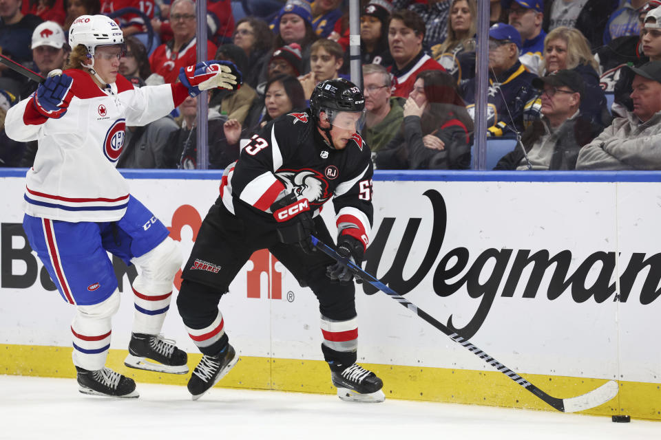 Buffalo Sabres left wing Jeff Skinner (53) takes the puck from Montreal Canadiens defenseman Kaiden Guhle (21) during the first period of an NHL hockey game Saturday, Dec. 9, 2023, in Buffalo, N.Y. (AP Photo/Jeffrey T. Barnes)