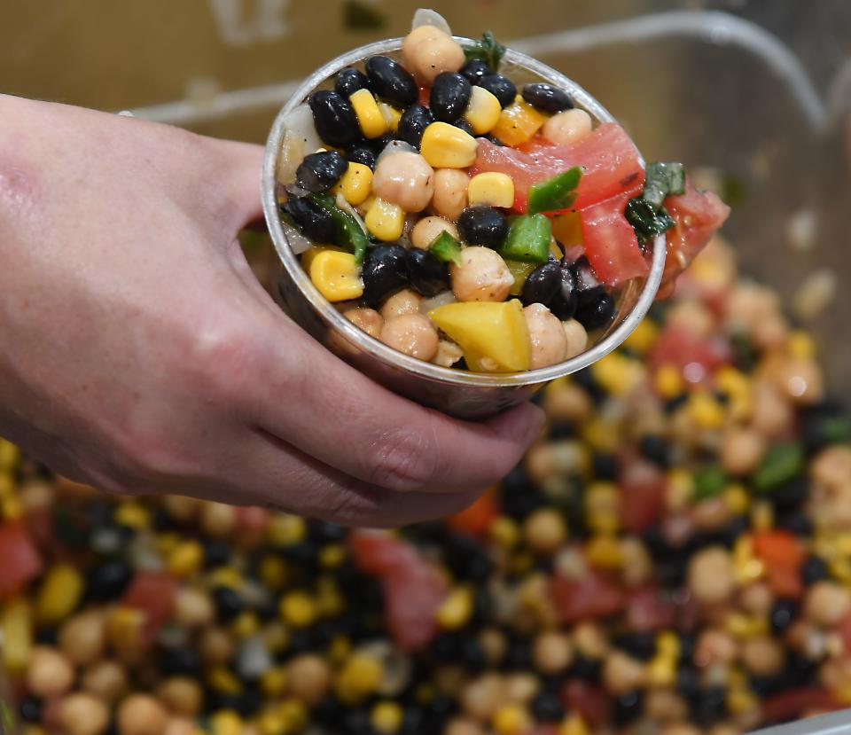 Jolly Rogers BBQ is now open in Pacolet. The business is owned by the husband and wife team of Josh and Jennifer Rogers. Here, Jennifer Rogers shows off a dish the team calls Carolina Caviar: black and other beans, tomato, onion, peppers, jalapeños, to name some of the ingredients in the dish.