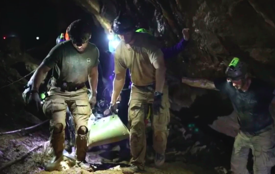 <em>Rescuers hold an evacuated boy inside the Tham Luang Nang Non cave in Mae Sai (AP)</em>