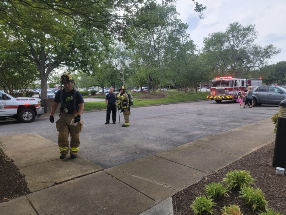 Firefighters and a firetruck arriving at a building